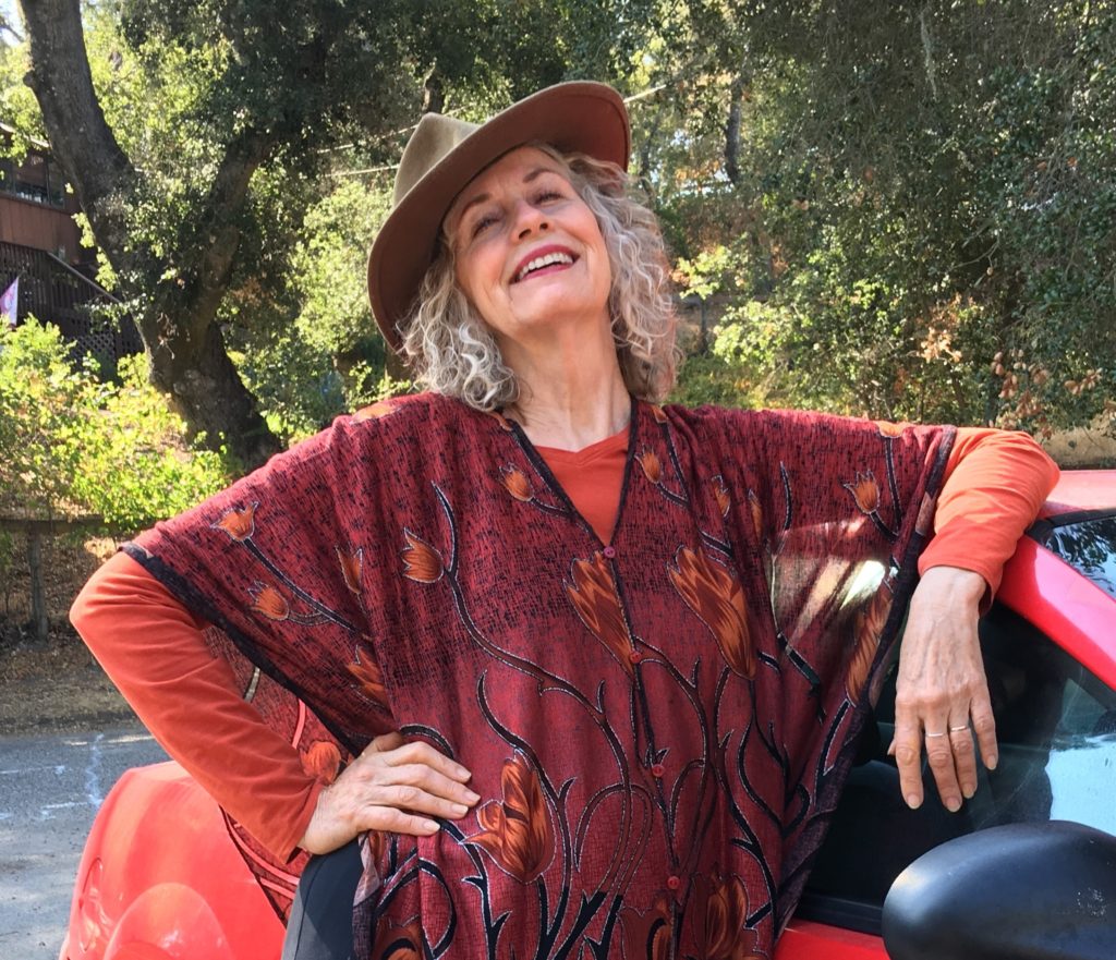 Author Shirley Radcliff Bruton standing in front of a car and smiling